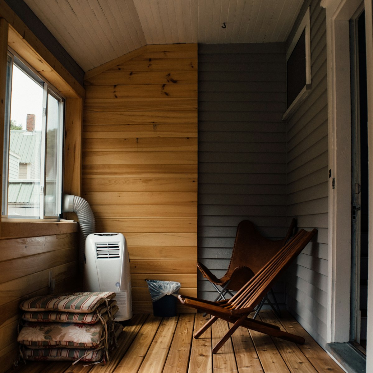 Covered terrace with timber lining and a lounge chair