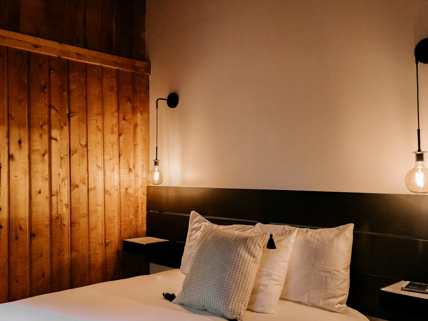 Bedroom with a full-height timber wall