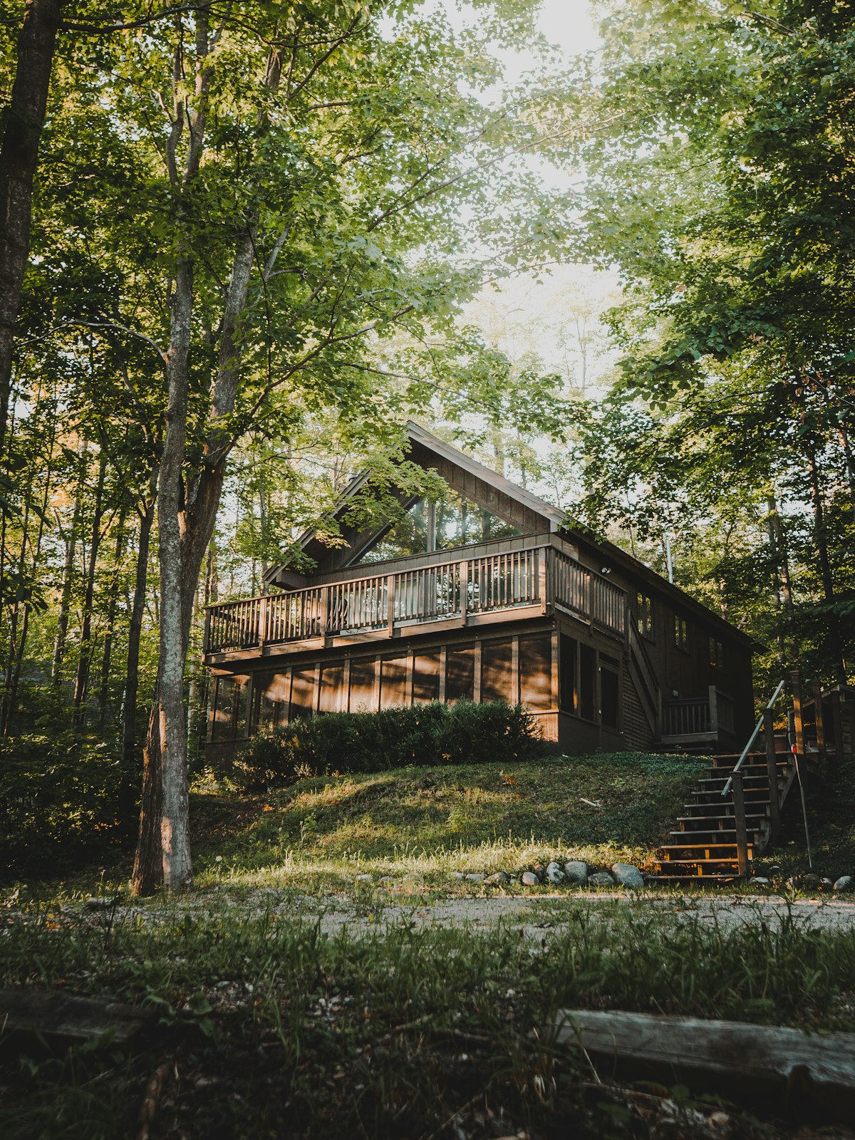 Kras — timber house with a wide covered deck among trees